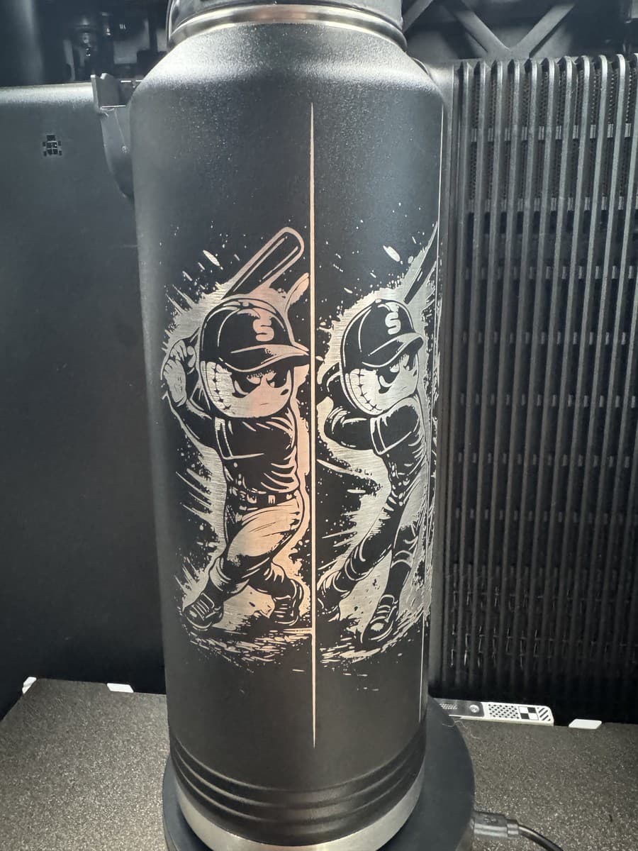 Black water bottle with baseball character artwork extending around the bottle