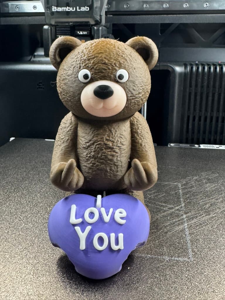Custom 3D-printed bear holding a purple heart that reads I Love You