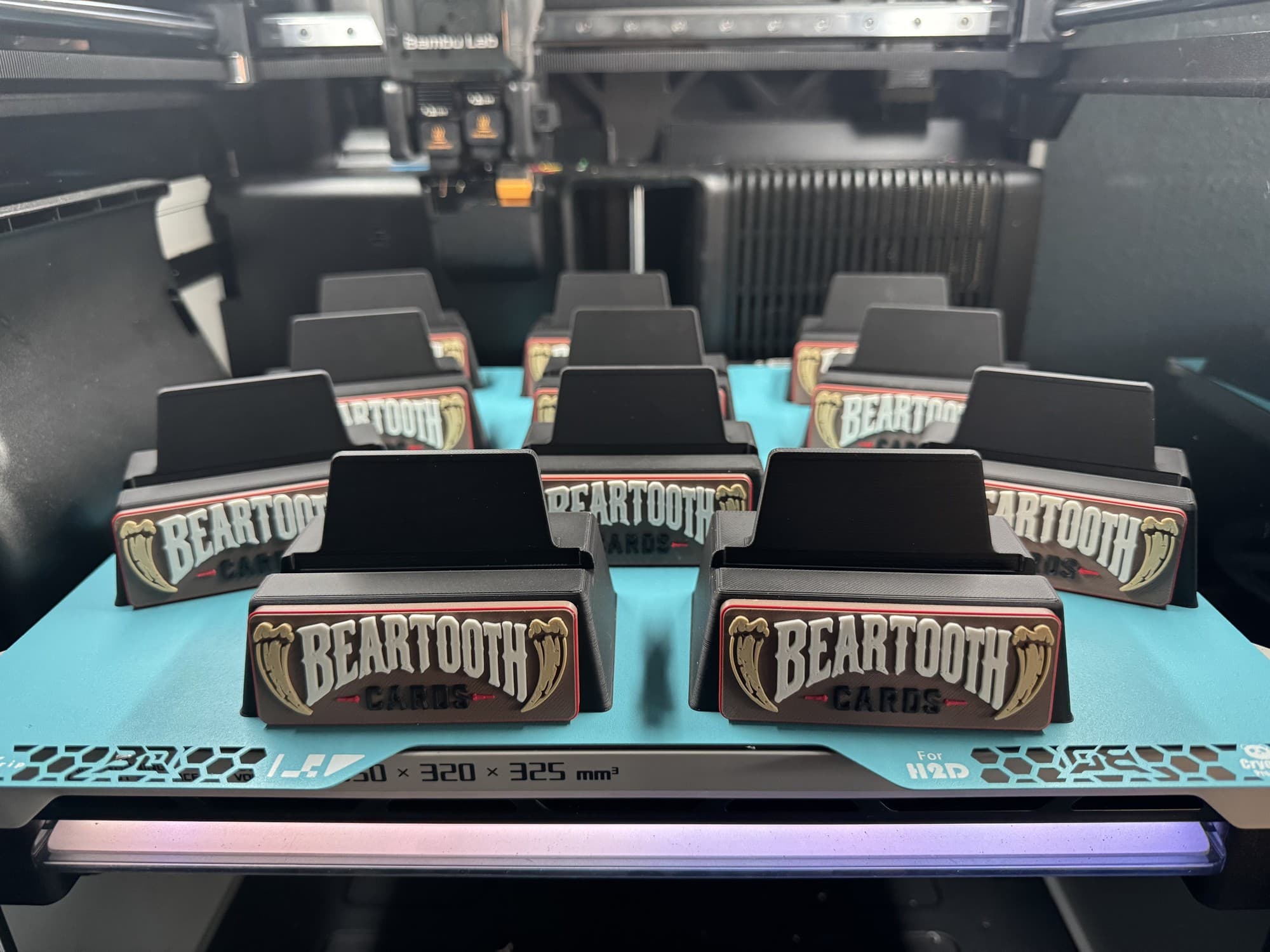 Multiple custom BearTooth Cards display stands arranged on a 3D printer build plate