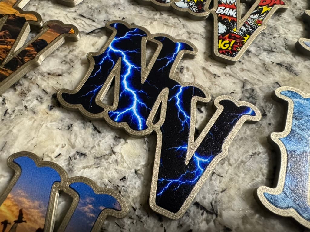 Raised NV helmet decal with blue lightning on a black background