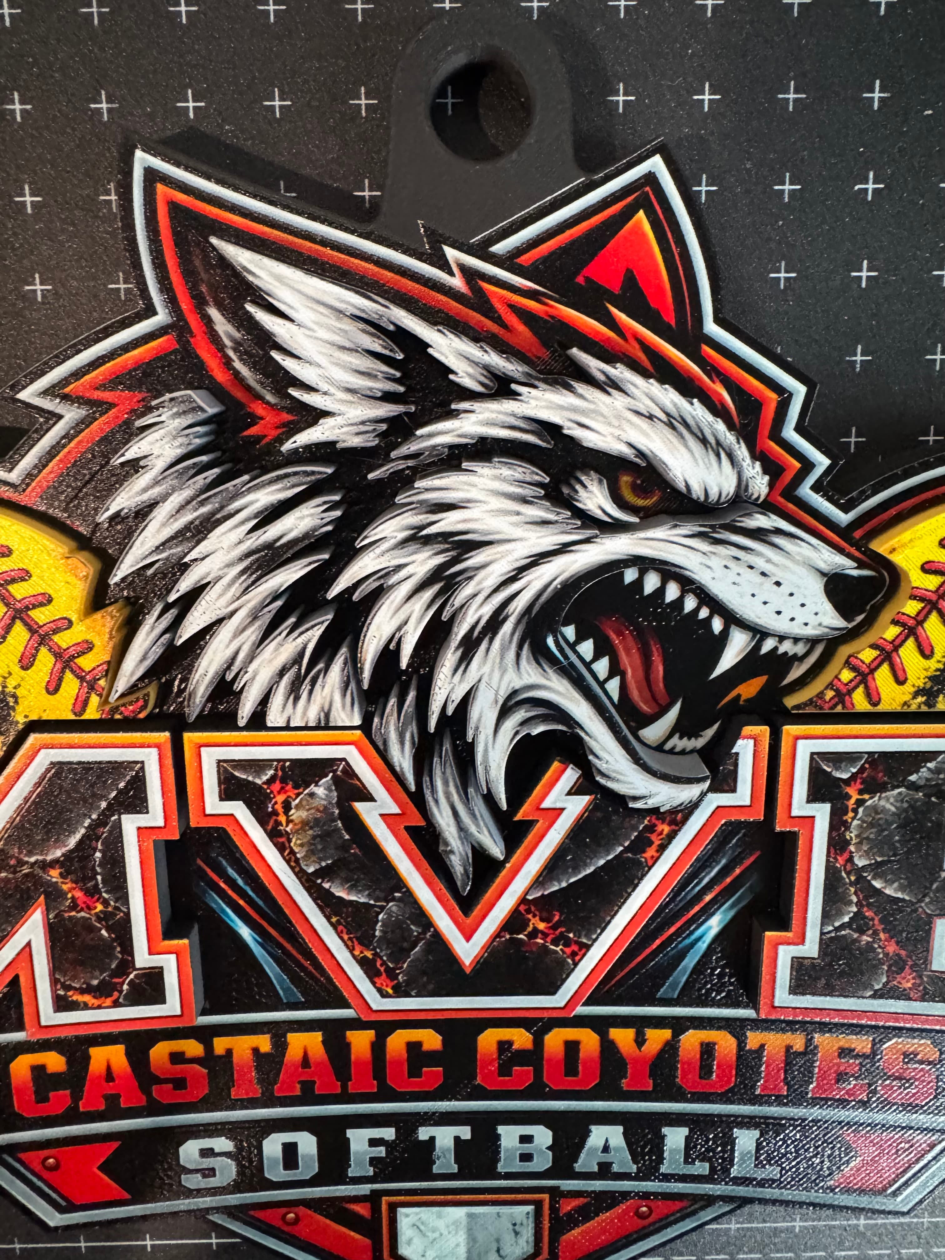 Close view of the coyote artwork, cracked-rock MVP lettering and Castaic Coyotes Softball banners