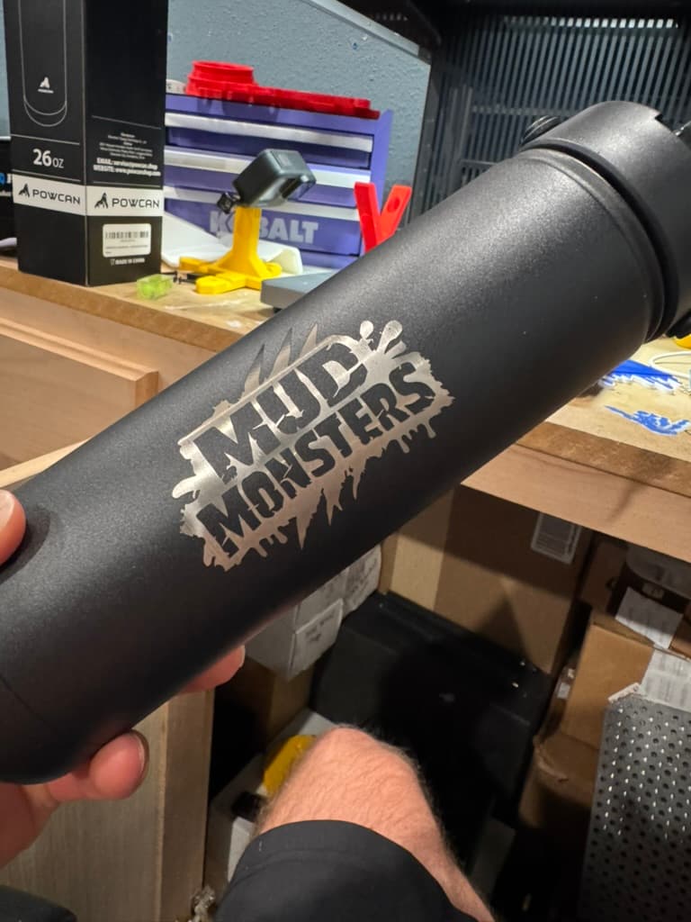 Custom Mud Monsters logo engraved on a black tumbler