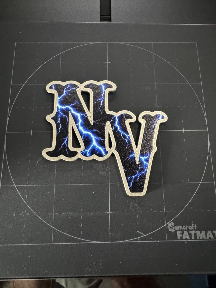NV helmet decal with blue lightning artwork on a cutting mat