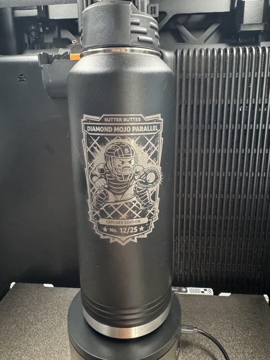 Black water bottle with detailed baseball catcher artwork