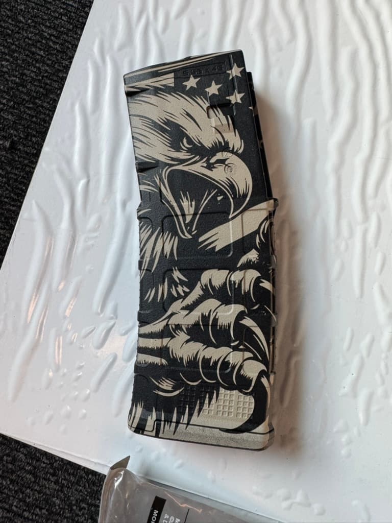 Close-up of a customer-owned PMAG with a detailed eagle engraving pattern