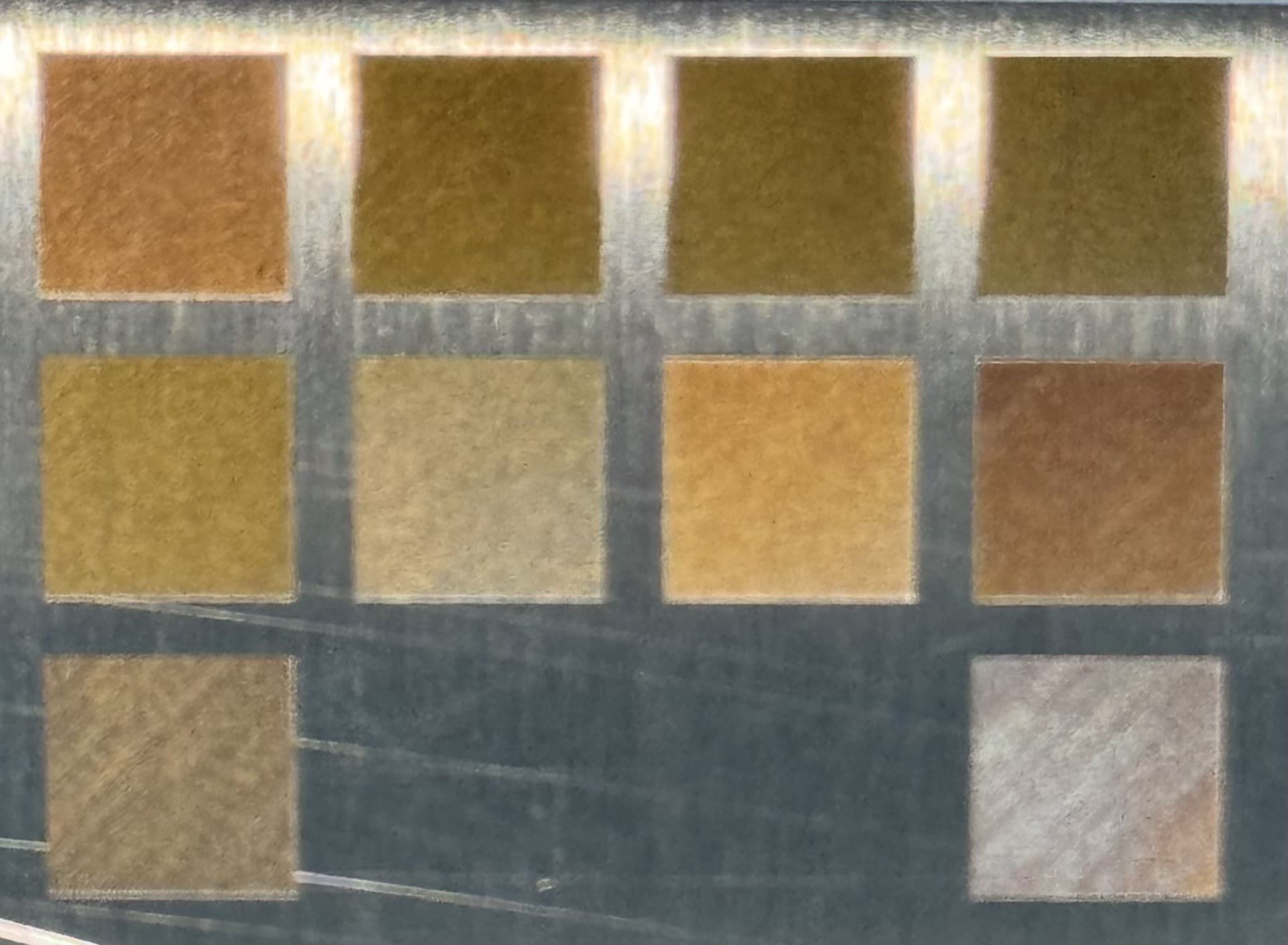 Post-burn photograph of the LAB-0004 12-cell validation grid on a 304 stainless mirror-finish coupon